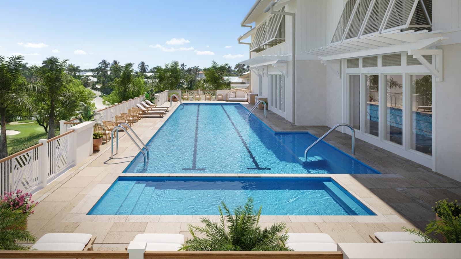 Sunlit rooftop lap pool at a luxury spa, with clear blue water, swim lanes, and steps, surrounded by white loungers, wicker chairs, palm trees, and a breezy coastal-style building overlooking tropical greenery.
